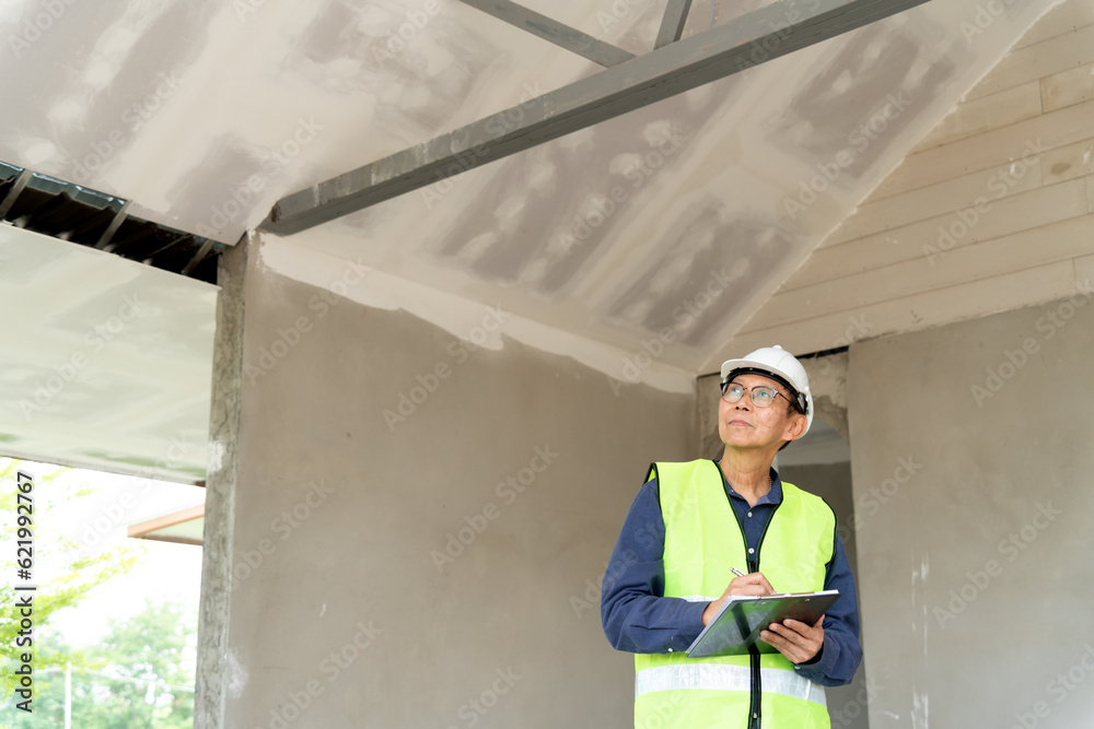 Construction supervisors are reviewing and writing checklists Construction supervisors are reviewing and writing checklists