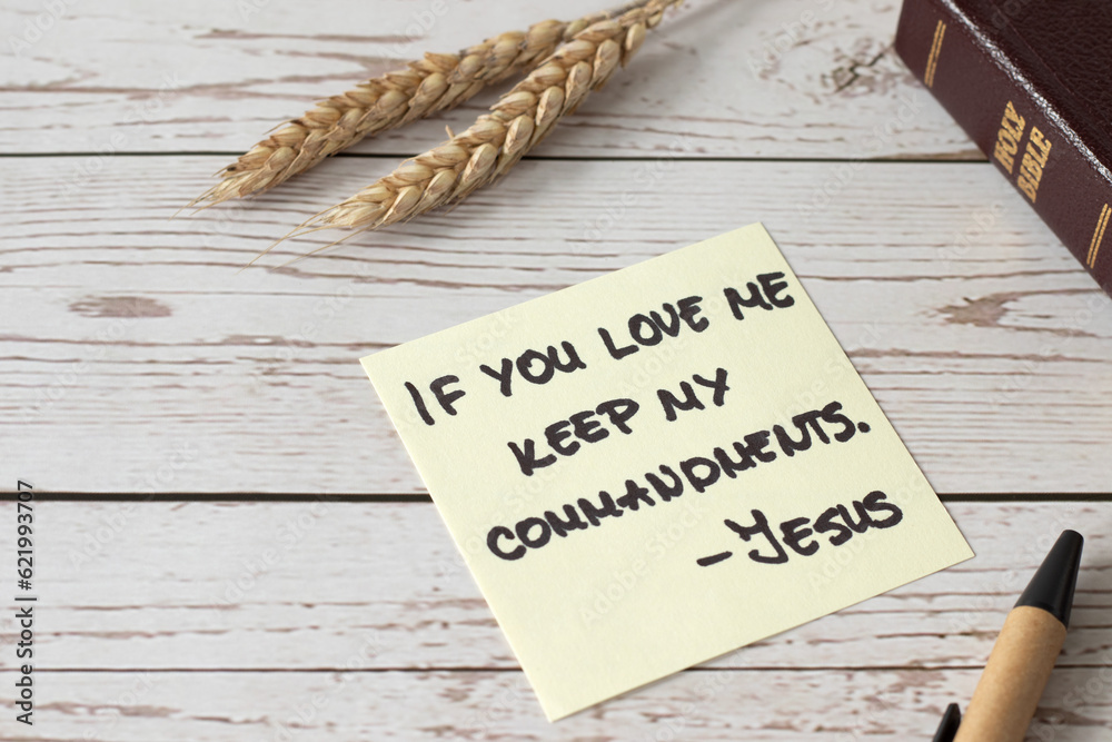 If you love Me, keep My commandments, Jesus Christ's words written in holy bible book with ripe wheat on wooden table. Close-up. Christian disciples obedience and faith in God, biblical concept. - obrazy, fototapety, plakaty 
