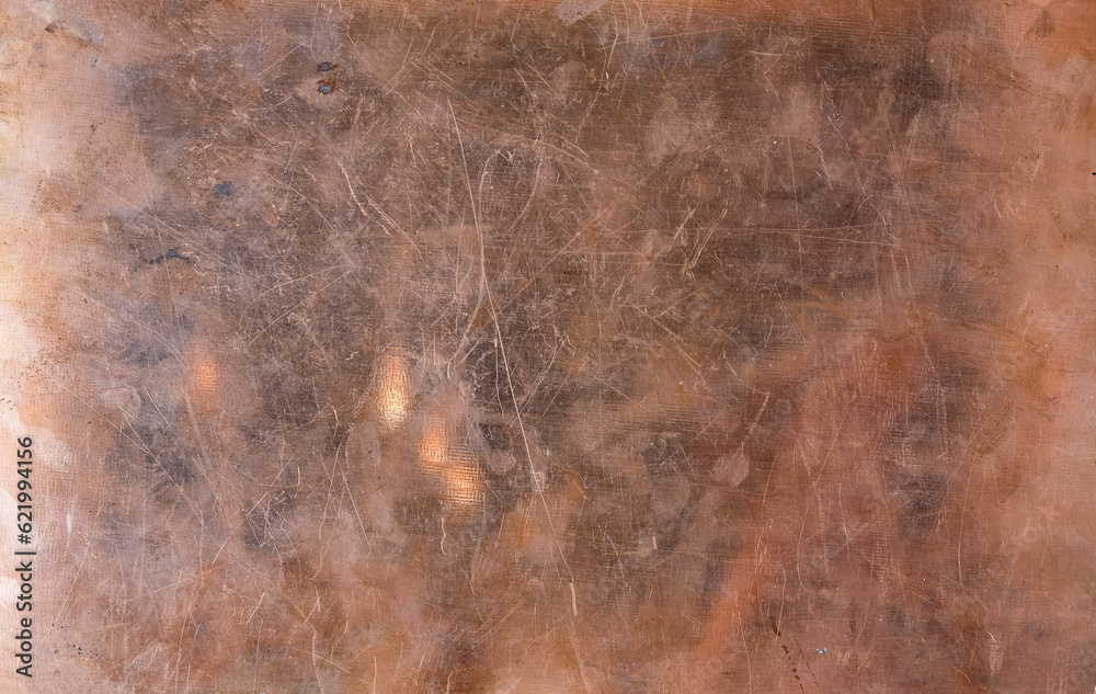 Worn copper foil. Background. Texture. Reflection. Sunlight. Copy space. Worn copper foil. Background. Texture. Reflection. Sunlight. Copy space.
