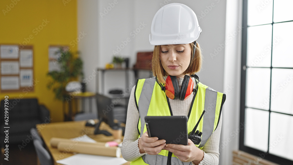 Young blonde woman architect using touchpad with serious expression at office Young blonde woman architect using touchpad with serious expression at office