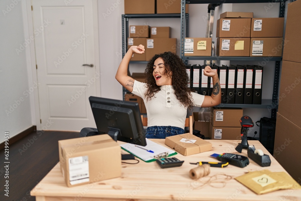 Young beautiful hispanic woman ecommerce business worker stretching arms yawning at office Young beautiful hispanic woman ecommerce business worker stretching arms yawning at office