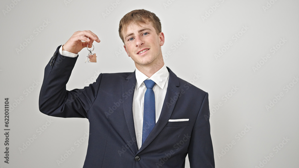 Young caucasian man real state agent holding keys of new home over isolated white background Young caucasian man real state agent holding keys of new home over isolated white background