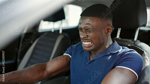 African american man stressed driving car at street © Krakenimages.com