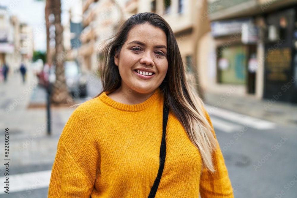 Young beautiful plus size woman smiling confident standing at street