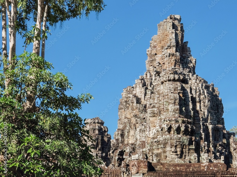 Famous for its architecture, Bayon Temple in Cambodia on a sunny warm day, landscape.