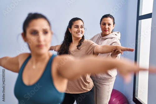 Three woman wearing sportswear training yoga at sport center © Krakenimages.com
