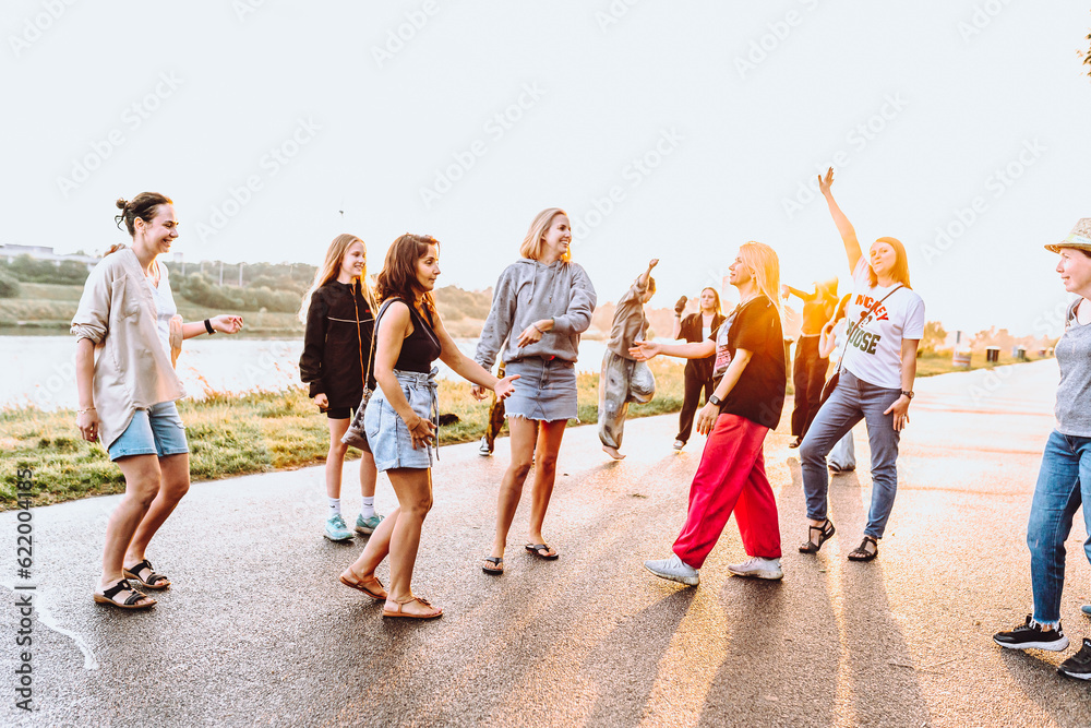 Obraz premium dancing cheerful attractive women at sunset. 