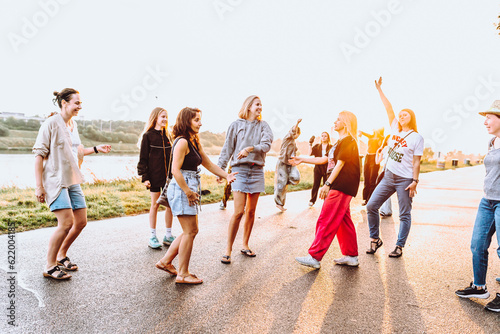 dancing cheerful attractive women at sunset.  © larisikstefania