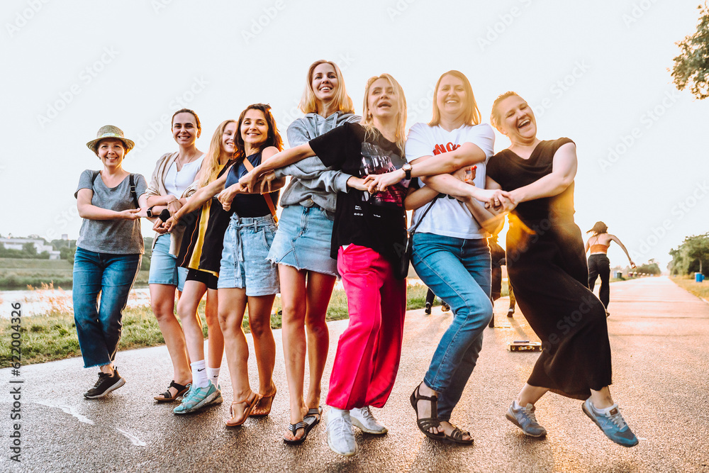 Obraz premium dancing cheerful attractive women at sunset. 