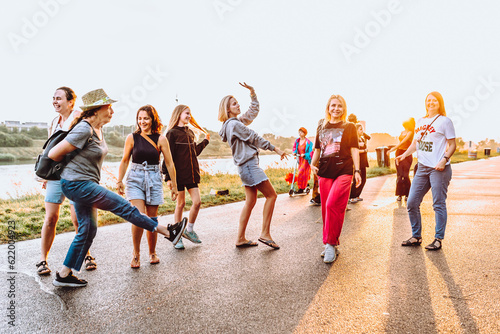 dancing cheerful attractive women at sunset.  © larisikstefania