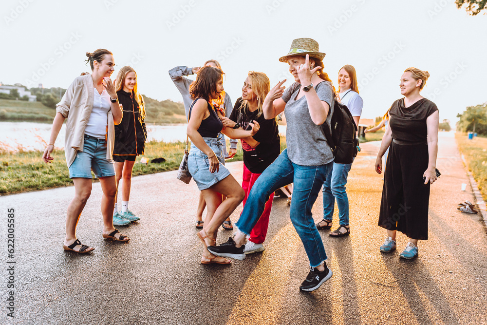 Obraz premium dancing cheerful attractive women at sunset. 