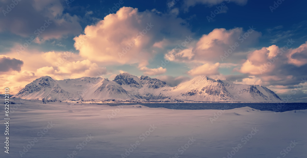 Panoramic landscape - winter mountains and cloudy sky under sunlight - typical north scenery. Stunning Lofoten islands. Wonderful nature of Norway