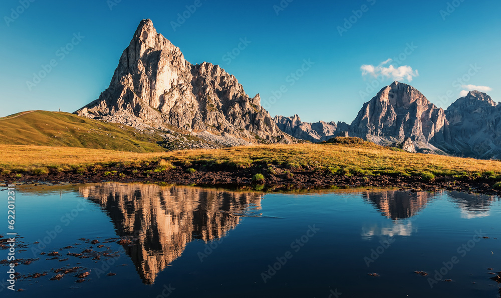 Fototapeta premium Amazing nature scenery. Mountains reflected in lake at sunset in autumn in Dolomites, Italy.