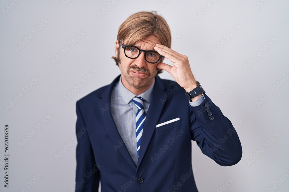 Caucasian man with mustache wearing business clothes worried and stressed about a problem with hand on forehead, nervous and anxious for crisis Caucasian man with mustache wearing business clothes worried and stressed about a problem with hand on forehead, nervous and anxious for crisis