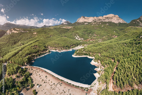 Aerial view of the reservoir pond with beautiful bluish green water among the mountains. Water reserves, ecology and hydroelectric power plants