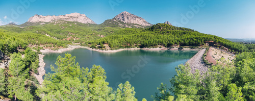 Aerial view of the reservoir pond with beautiful bluish green water among the mountains. Water reserves, ecology and hydroelectric power plants