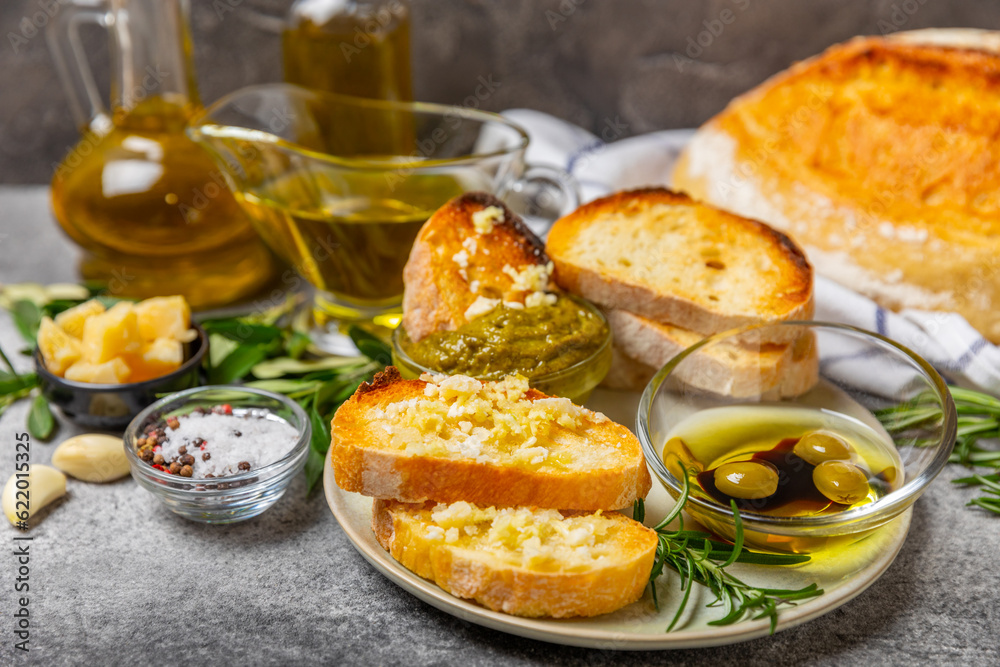 Bruschetta with olive oil, olives, pesto, garlic and parmesan. ciabatta bread with olive oil and spices. Delicacy. Delicious and healthy food. Vegan. Place to copy. copy space.