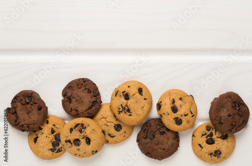 Flat lay with chocolate chip cookies on wooden background