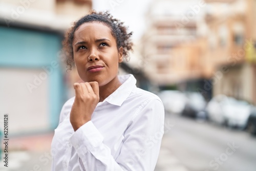 African american woman standing with doubt expression at street