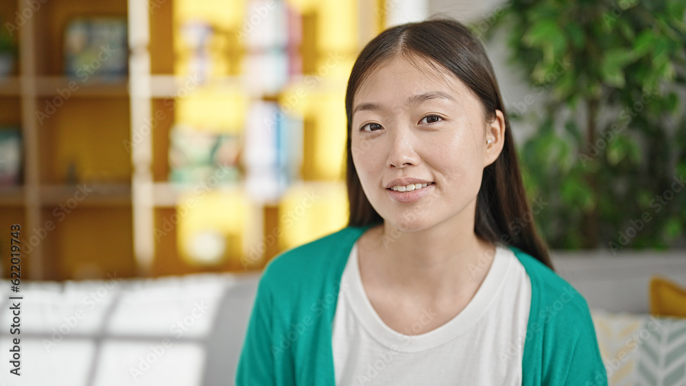 Young chinese woman smiling confident sitting on sofa at home Young chinese woman smiling confident sitting on sofa at home