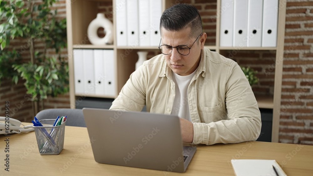 Young hispanic man business worker using laptop at office Young hispanic man business worker using laptop at office