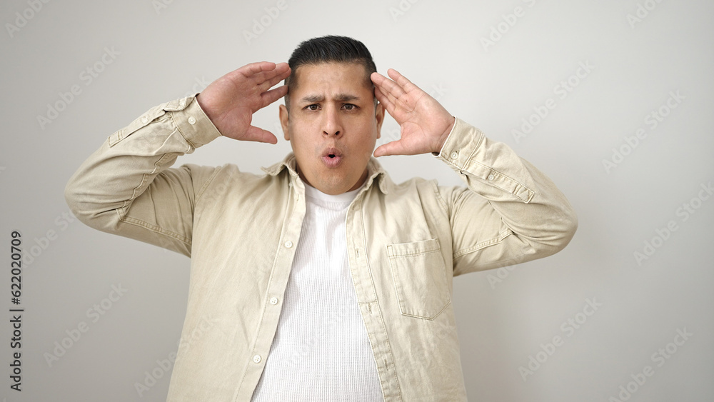 Young hispanic man standing with surprise expression over isolated white background Young hispanic man standing with surprise expression over isolated white background