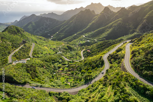 Fototapeta Aerial view of green volcanic landscape with mountain road in Tenerife