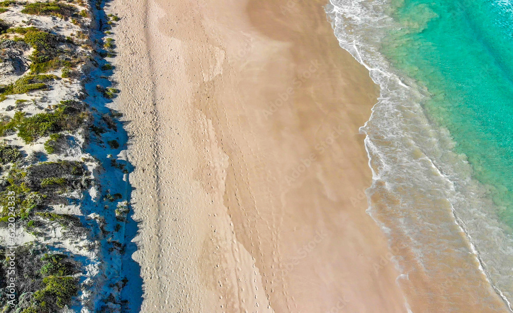 Above the ocean, aerial view at the waves and surface near shoreline - Drone viewpoint Above the ocean, aerial view at the waves and surface near shoreline - Drone viewpoint