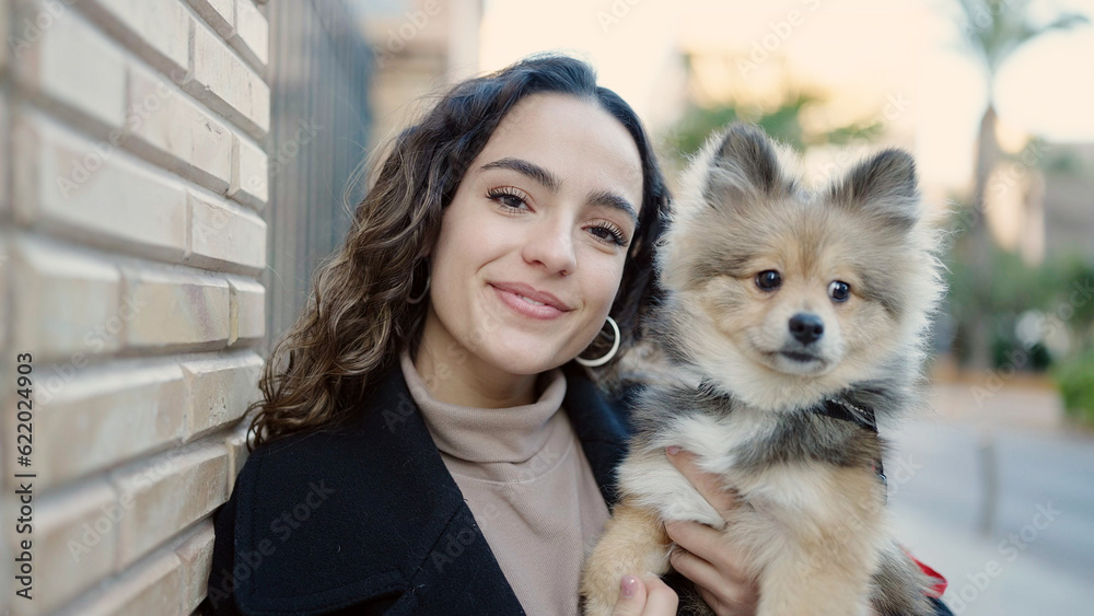 Young hispanic woman with dog smiling confident standing at street Young hispanic woman with dog smiling confident standing at street