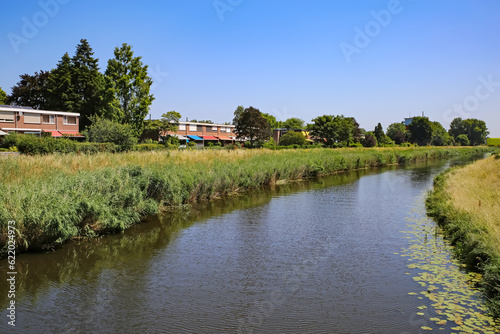 Beautiful idyllic Aa river landscape on the outskirts of dutch city, waterfront homes - S-Hertogenbosch, Netherlands