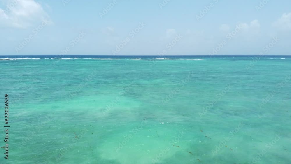 Drone view of blue Caribbean Sea with transparent water and blue sky on a sunny and hot day in Tulum Drone view of blue Caribbean Sea with transparent water and blue sky on a sunny and hot day in Tulum