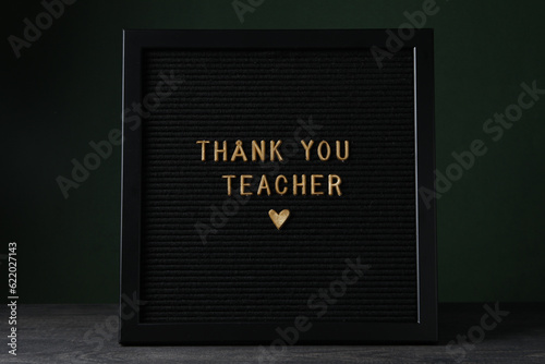 The inscription on the dark board: "Thank you, teacher!"