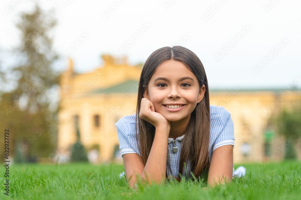 positive girl relax at summer lawn with grass. girl relax at summer lawn outdoor. positive girl relax at summer lawn with grass. girl relax at summer lawn outdoor.