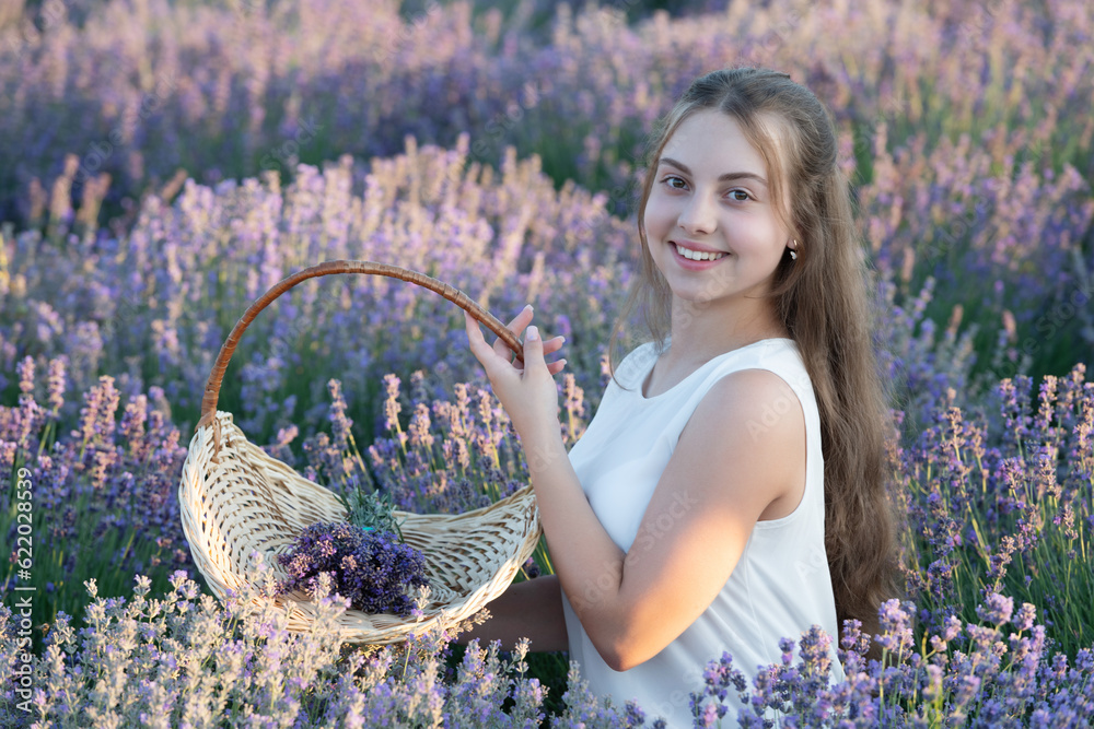 positive girl in lavender flowers field. teen girl holding a lavender ...