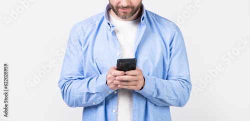 cropped view of man write message on phone isolated on studio background. © be free