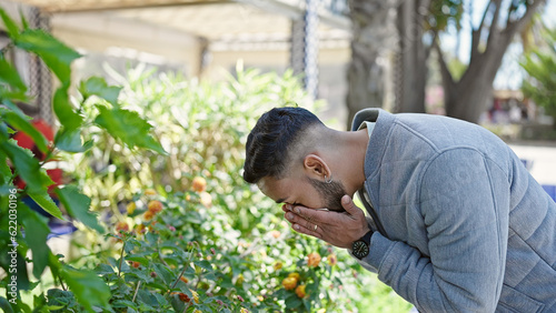 Young hispanic man with pollen allergy sneezing at park © Krakenimages.com