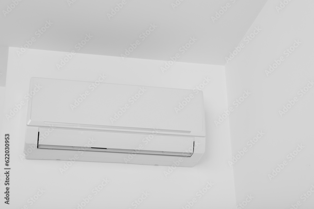 White air conditioner on the wall in the apartment White air conditioner on the wall in the apartment