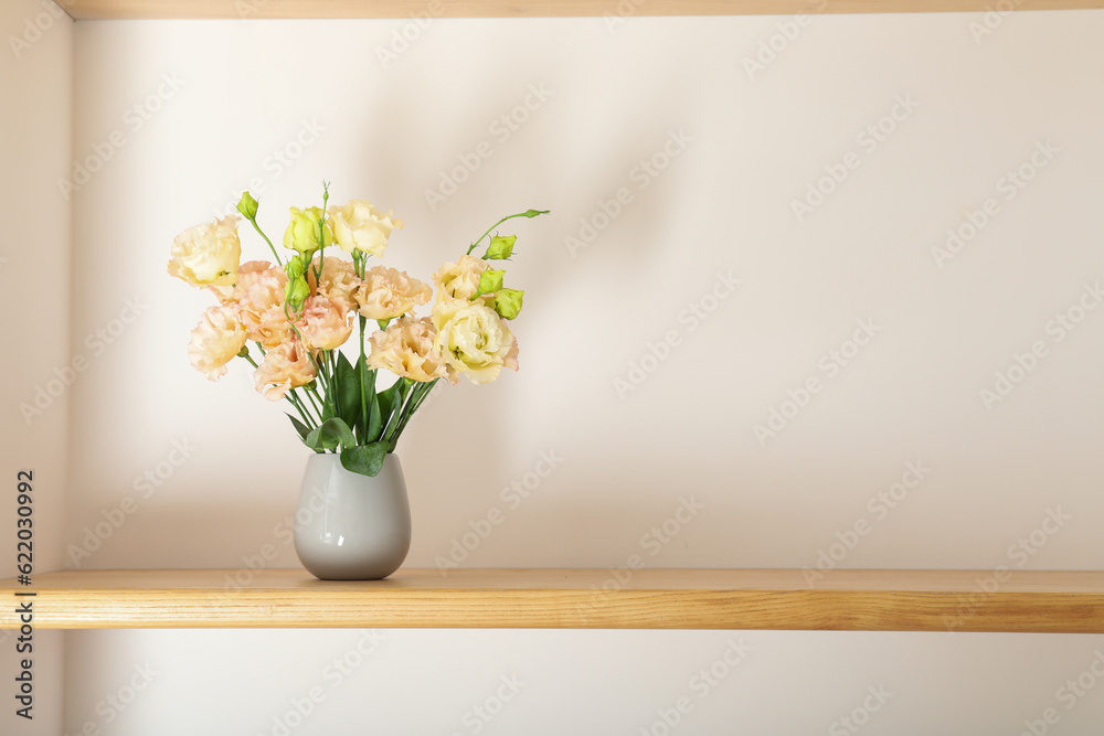 A beautiful vase with flowers on a shelf