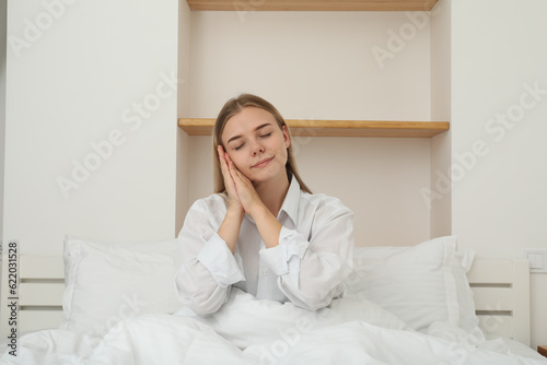 A young girl in bed wants to sleep