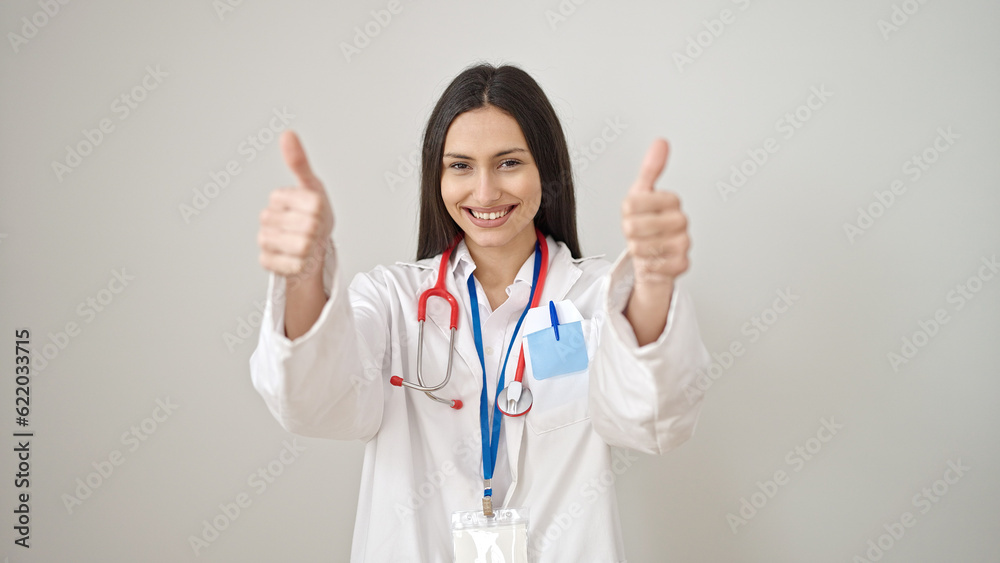 Young beautiful hispanic woman doctor doing thumbs up over isolated white background Young beautiful hispanic woman doctor doing thumbs up over isolated white background