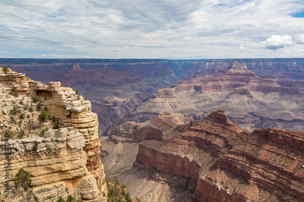 Massive rock formation with panoramic view of O Neill Butte seen from South Kaibab hiking trail at South Rim of Grand Canyon National Park, Arizona, USA. Colorado River weaving through rugged terrain