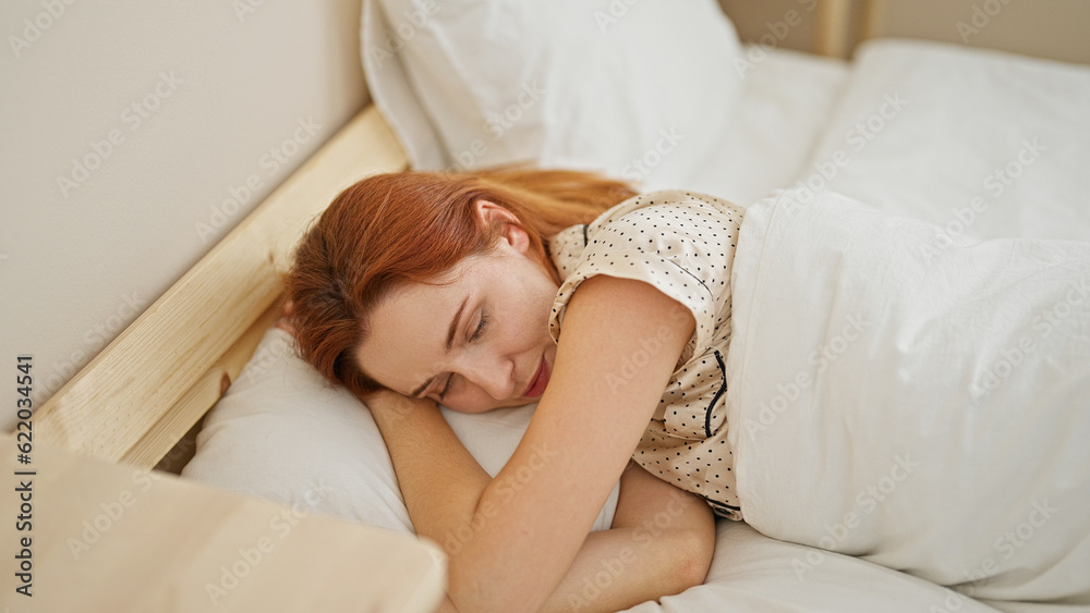Young redhead woman lying on bed sleeping at bedroom Young redhead woman lying on bed sleeping at bedroom