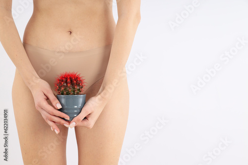 A girl in underwear with a cactus in her hands