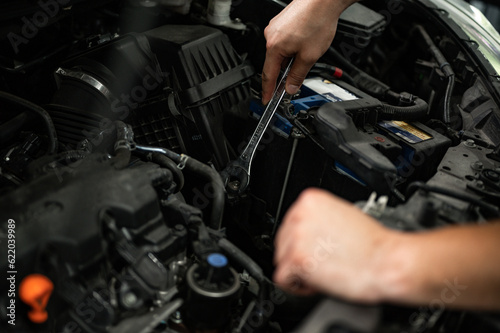 car mechanic changing car engine