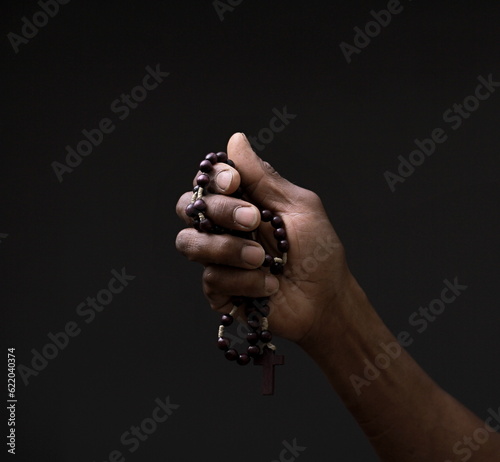 man praying to god with hands together Caribbean man praying on black background with people stock image sock photo