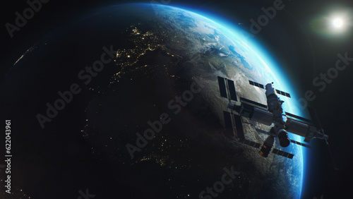 Earth globe rotating in outer space. Satellite or ISS flies in planet orbit. View of the night cities lights from space. Day-night transition. Discovery and exploration concept.