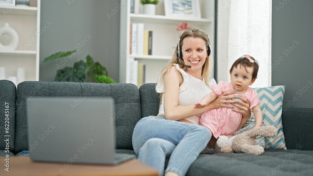 Mother and daughter working while care baby at home