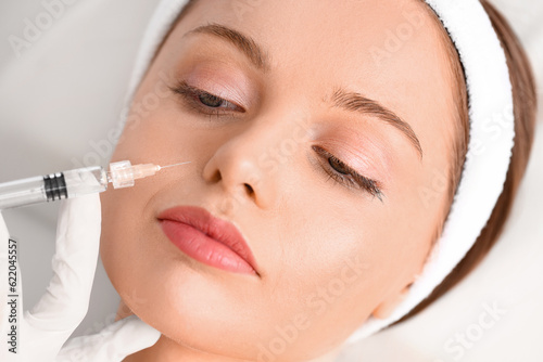 Young woman receiving facia...