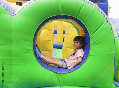 сute little girl on an inflatable trampoline
