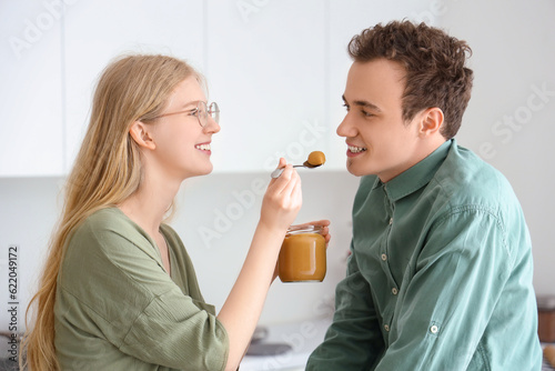 Young woman feeding her boy...
